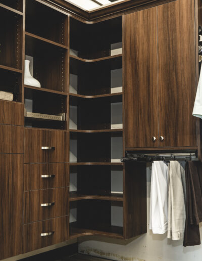 Custom Designed and Organized Closet with shelves, drawers, and hanging racks.