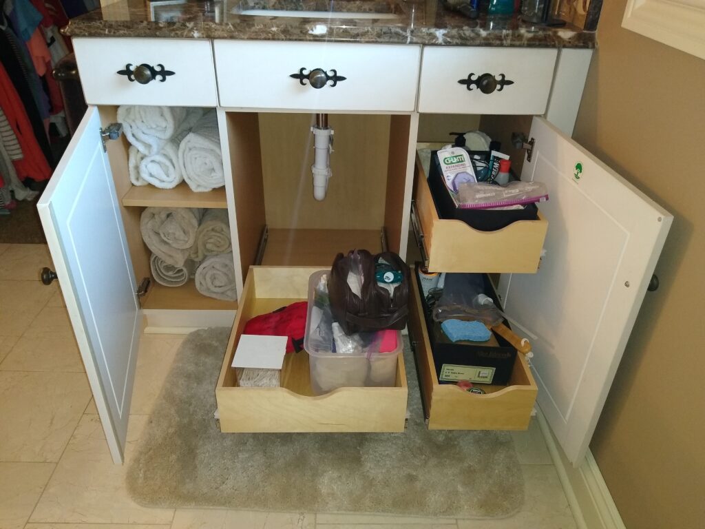 Custom designed and installed bathroom slide out shelves.