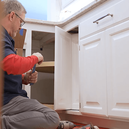 Jeff Knetzer working on a cabinet