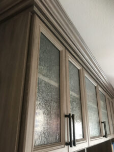 Close up of Glass Front Doors and Crown Moulding